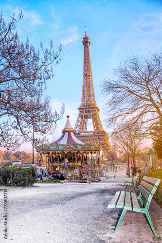 The Eiffel Tower and vintage carousel on a winter evening in Paris, France.