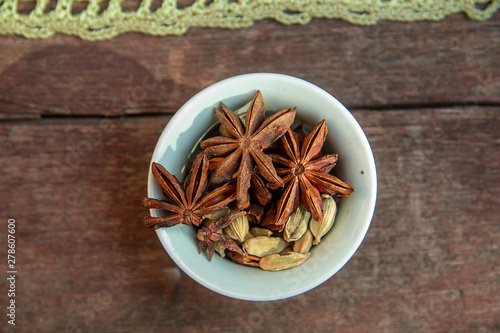 star anise and cardamom in a green bowl