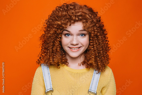 Canvas Print Beautiful red-haired woman with perfect curly hair smiling looking at camera