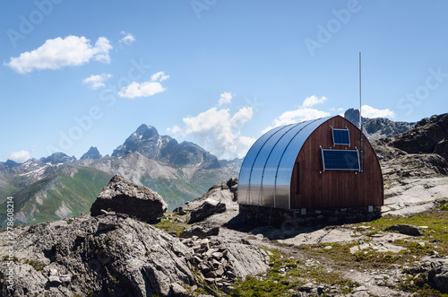 Exterior the longet pass olivero mountain bivouac (free sleeping shelter) in the piedmontese alps (Italy), facing the famous peak of Monviso (Mount Viso) photo