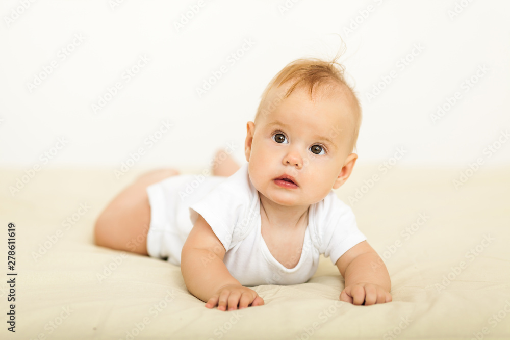 Portrait of happy smile baby relaxing on the bed