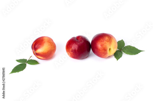 Three red bald peaches on white background. Peaches close up red color.