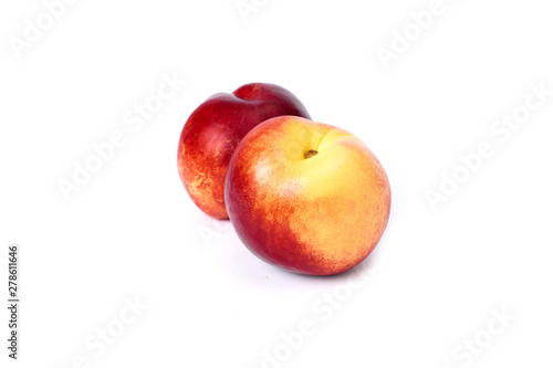 Two red bald peaches on white background. Peaches close up red color.