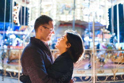 man and woman looking at each other at merry-go-round