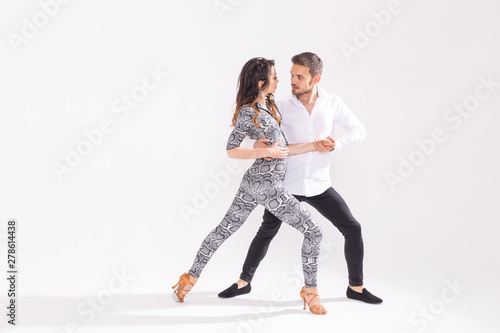 Passionate couple dancing social danse kizomba or bachata or semba or taraxia on white background with copy space