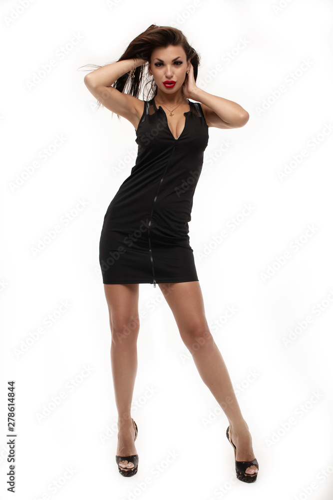 Sexy young brunette woman, wearing a mini black dress, in glamour full length, on white background. Sexy young brunette woman, wearing a mini black dress, in glamour full length, on white background.