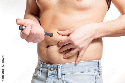 Male Injecting insulin in stomach (abdomen) on isolated white background