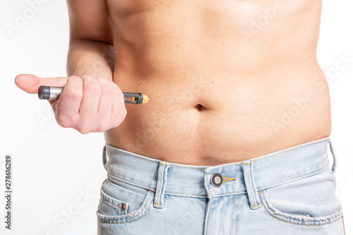 Male Injecting insulin in stomach (abdomen) on isolated white background