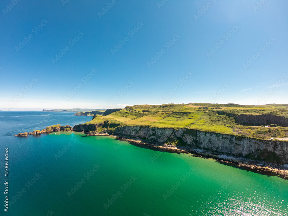 Carrick a Rede Rope Bridge in Ballintoy Northern Ireland. Aerial view on Cliffs and turquoise Atlantic Ocean water