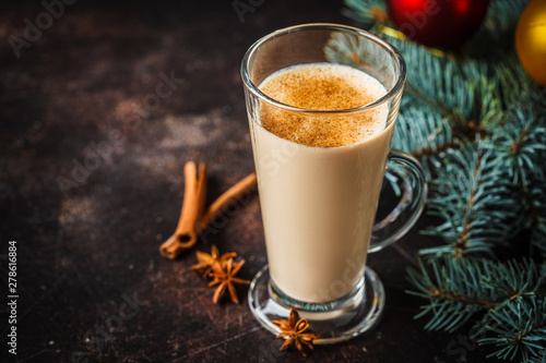 Christmas eggnog in a glass in Christmas background, copy space.