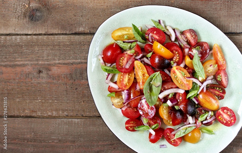 cherry tomatoes salad of different colors and basil. bright summer salad. cherry tomatoes salad of different colors and basil. bright summer salad.