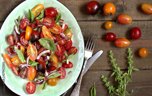  cherry tomatoes salad of different colors and basil. bright summer salad. 