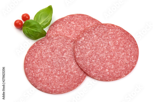 Salami sausage slices with basil leaves, top view, isolated on white background