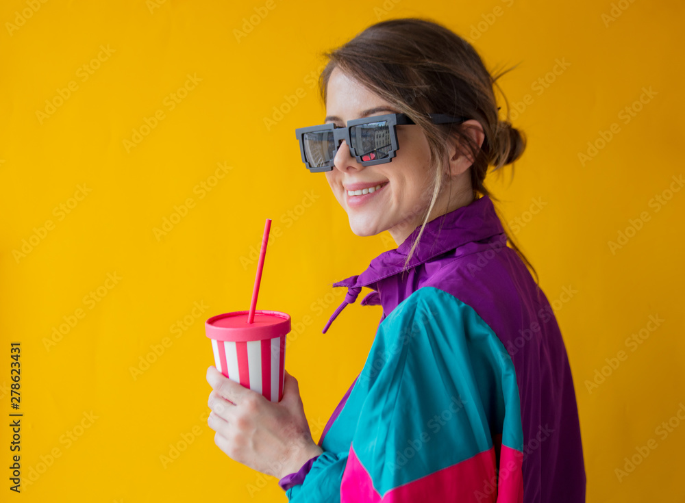 Young woman in 90s style clothes with cup