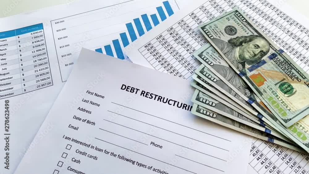 Debt restructuring document with graph on table. Debt restructuring document with graph on table.