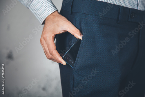 man hand phone on poket on abstract background photo