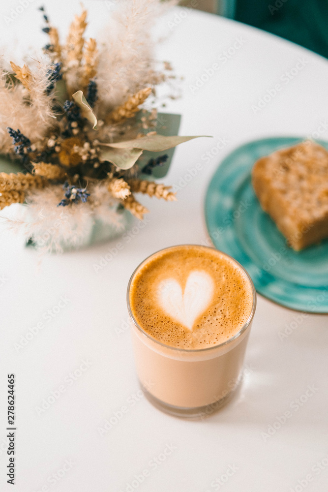 The cup of coffee with sweet cake in the coffee shop The cup of coffee with sweet cake in the coffee shop