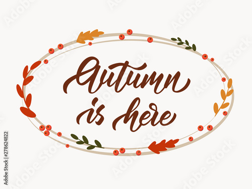 Autumn is here - hand lettering inscription on white background. Ellipse frame with autumn leaves and rowan berries. Vector illustration.