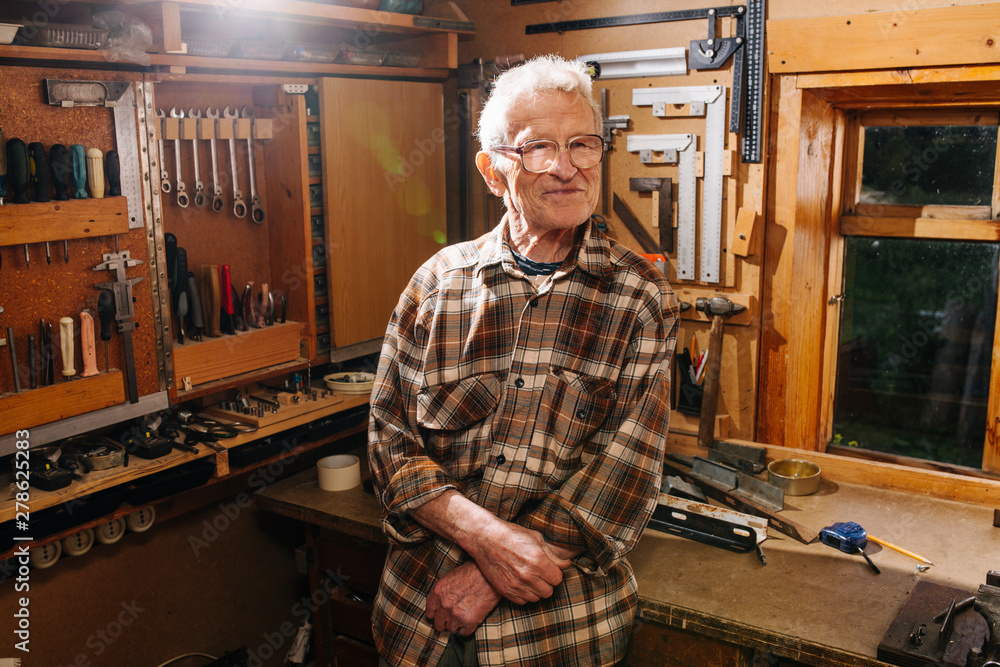 Portrait of amateur senior carpenter, taking pride in his workshop Portrait of amateur senior carpenter, taking pride in his workshop