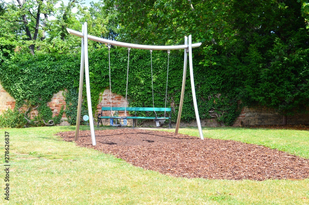 Playground with playground equipment like swing slide and seesaw