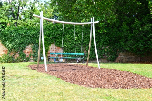 Playground with playground equipment like swing slide and seesaw
