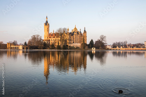 Dawn at Schwerin Palace (Schweriner Schloss), reflected in the water of Schweriner See lake. World Heritage Site in Mecklenburg-Vorpommern, Germany