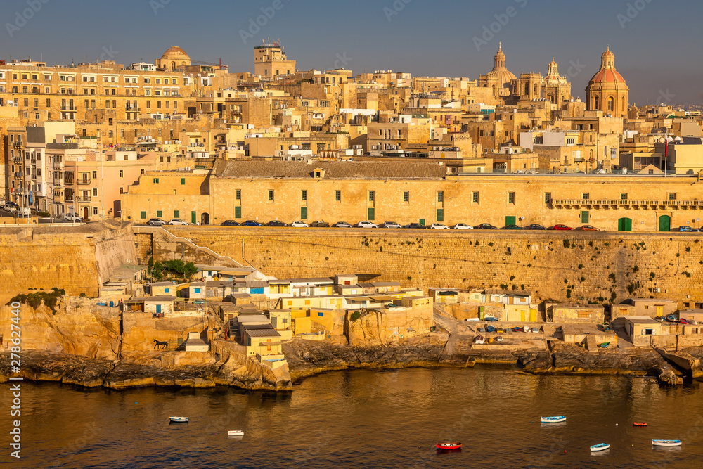 Fototapeta premium Valletta from the Ship. Exposure of Valletta, Malta, taken at Sunrise from a ship while arriving at this beautiful fortified city.