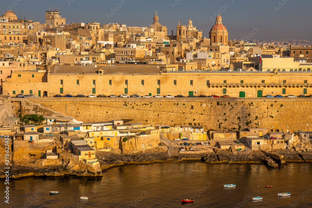 Fototapeta premium Valletta from the Ship. Exposure of Valletta, Malta, taken at Sunrise from a ship while arriving at this beautiful fortified city.