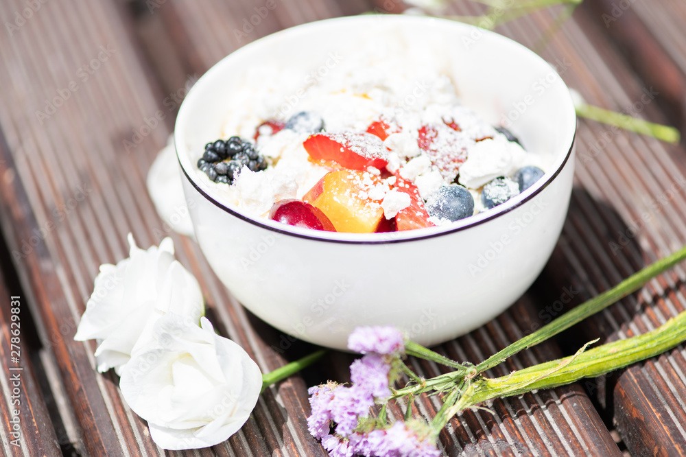 Bowl of healthy fresh fruit salad with cheese on the wooden background. Bowl of healthy fresh fruit salad with cheese on the wooden background.