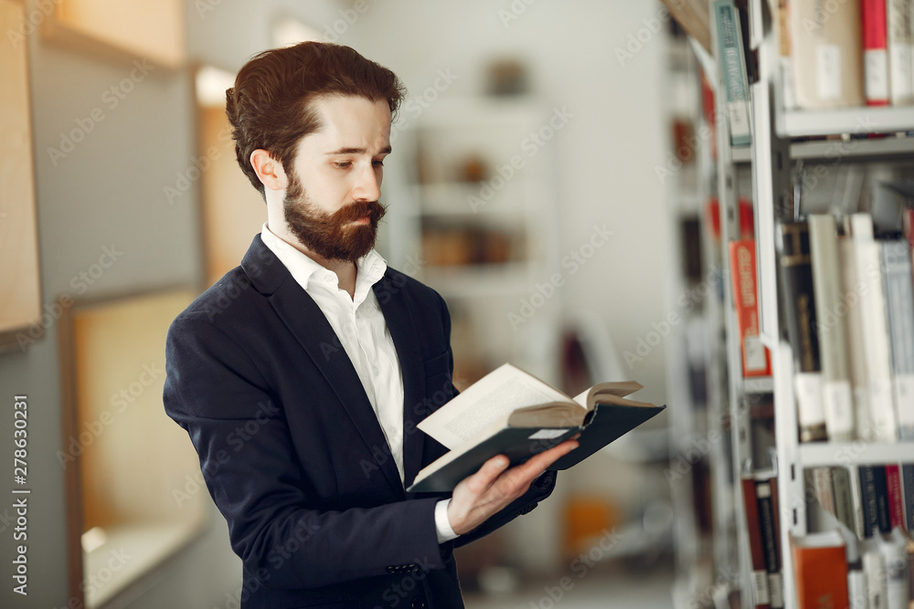 Man in a library. Guy in a black suit. Student with a books. Man in a library. Guy in a black suit. Student with a books.