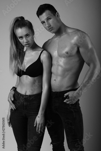 Black and white fashion shoot of young couple with nice body.