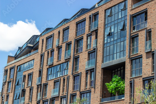 Side shoot of brick and open glazing facade office building