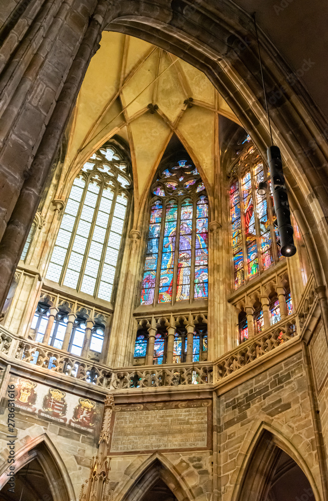 Three religious stained-glass windows in the corner of gothic european cathedral