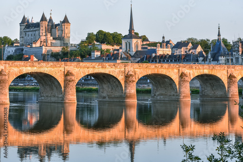 Views of the city of Saumur from the riverbank at dusk, with the castle in the background. Loire Valley, France. photo
