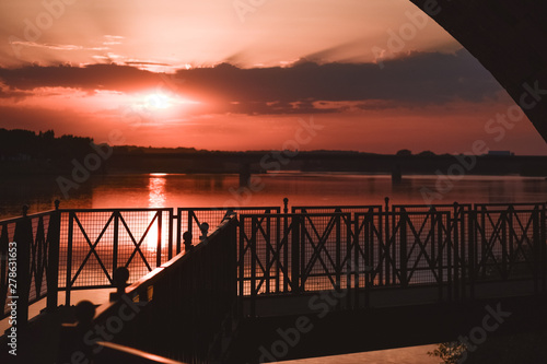 Riverside walk in a colorful sunset backlight © dhvstockphoto