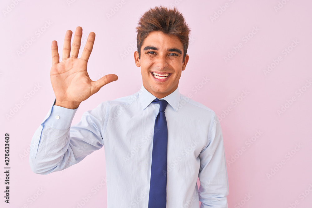 Young handsome businessman wearing shirt and tie standing over isolated pink background showing and pointing up with fingers number five while smiling confident and happy. Young handsome businessman wearing shirt and tie standing over isolated pink background showing and pointing up with fingers number five while smiling confident and happy.
