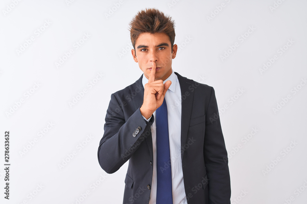 Young handsome businessman wearing suit standing over isolated white background asking to be quiet with finger on lips. Silence and secret concept. Young handsome businessman wearing suit standing over isolated white background asking to be quiet with finger on lips. Silence and secret concept.