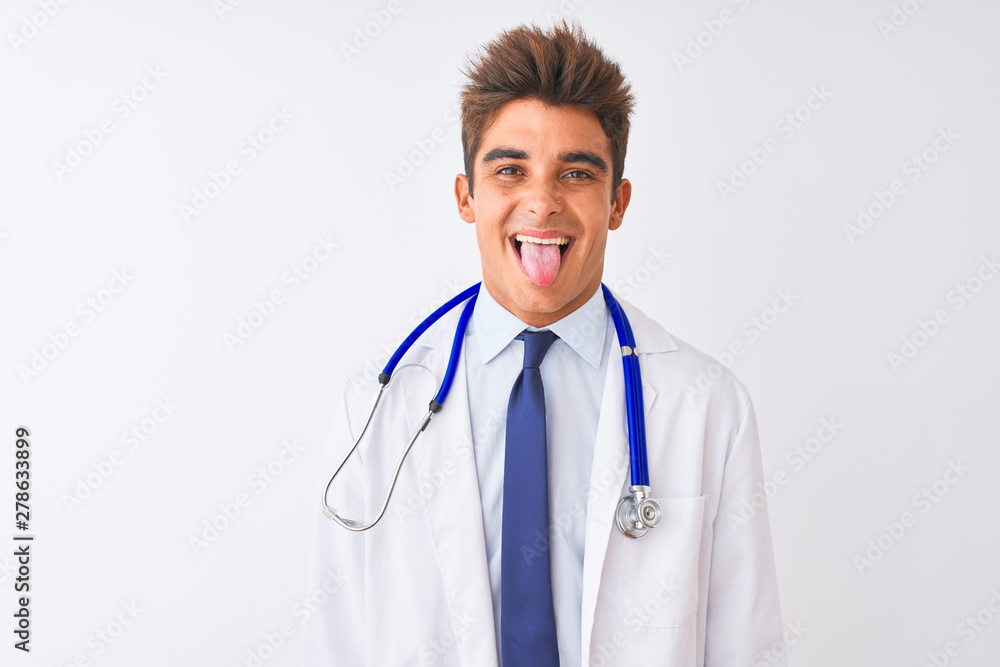 Young handsome doctor man wearing stethoscope over isolated white background sticking tongue out happy with funny expression. Emotion concept. Young handsome doctor man wearing stethoscope over isolated white background sticking tongue out happy with funny expression. Emotion concept.