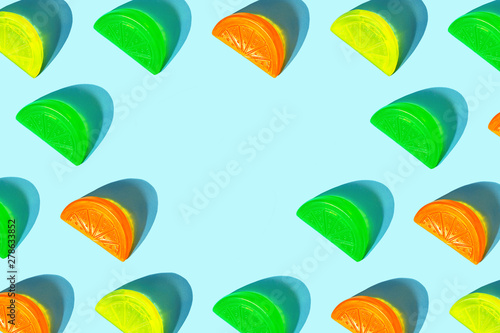 Creative pattern of colorful citrus slices like ice for cocktail on pastel blue background. Pop art minimal flat lay style design, summer drink creative concept. Top view, flatlay. Copy space.