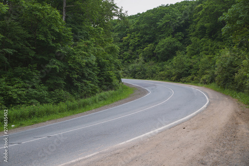 the road in the mountain range  sharp turns of the road in the forest