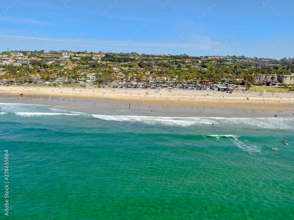 Aerial view of La Jolla coastline with nice small waves, tourist enjoying the sun and beautiful villas in the background. La Jolla, San Diego, California, USA. Beach with pacific ocean. Aerial view of La Jolla coastline with nice small waves, tourist enjoying the sun and beautiful villas in the background. La Jolla, San Diego, California, USA. Beach with pacific ocean.
