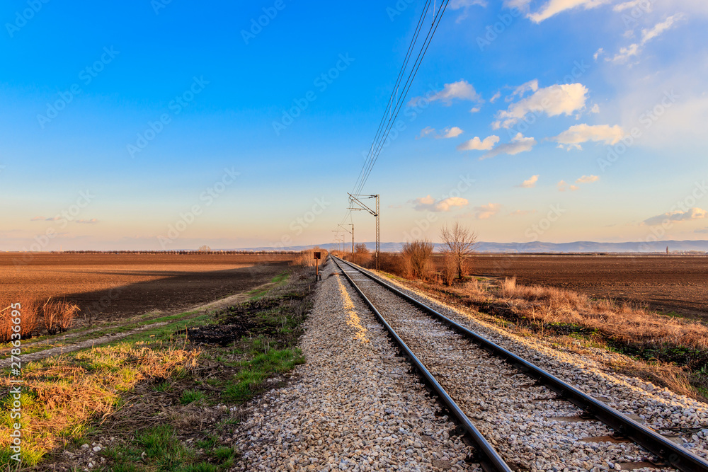 Railway line between the agricultural fields in March, Serbia
