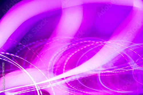 Colorful pattern of purple and pink dynamic neon lines. Modern background. Art concept of lighting effects.