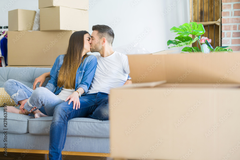 Young couple in love relaxing sitting on the sofa at new home, smiling happy for moving to new apartment Young couple in love relaxing sitting on the sofa at new home, smiling happy for moving to new apartment