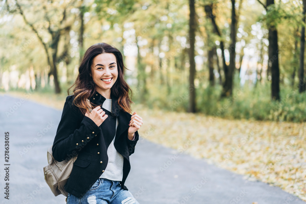 Pretty long hair brunette girl relaxing in the park, autumn time. Pretty long hair brunette girl relaxing in the park, autumn time.