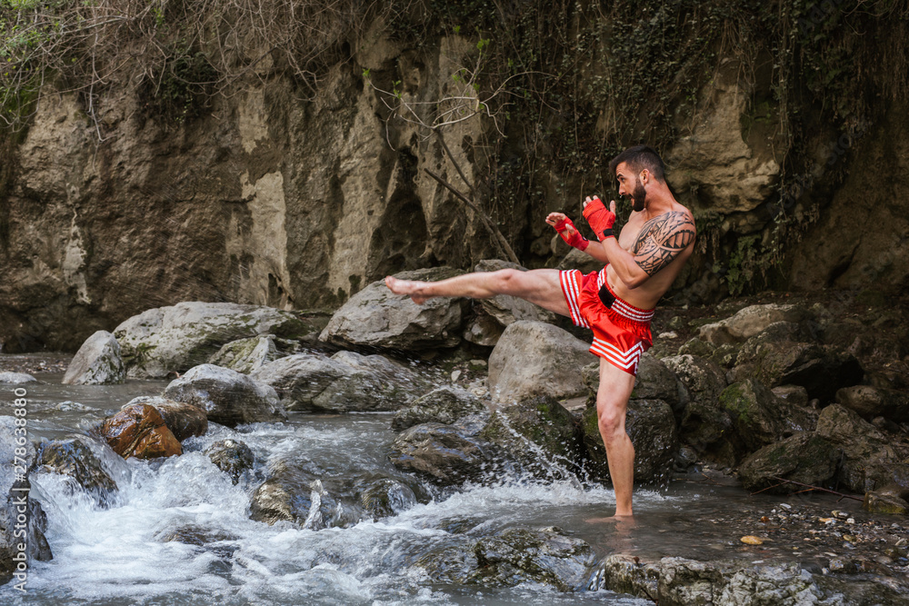 Young man doing boxing workout in nature Young man doing boxing workout in nature