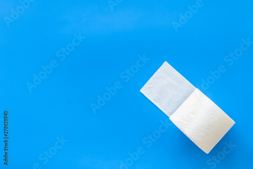 Proctology concept with toilet paper on blue background top view mock up