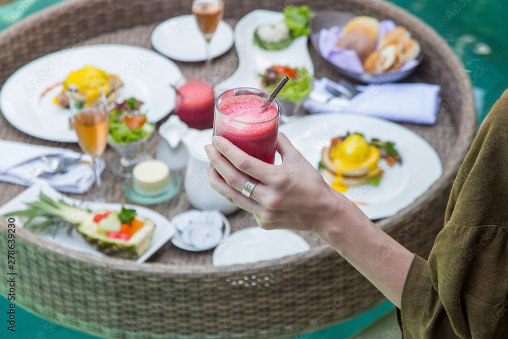 Close up image of a woman drinking detox juice, a healthy breakfast as a good start of a day Close up image of a woman drinking detox juice, a healthy breakfast as a good start of a day