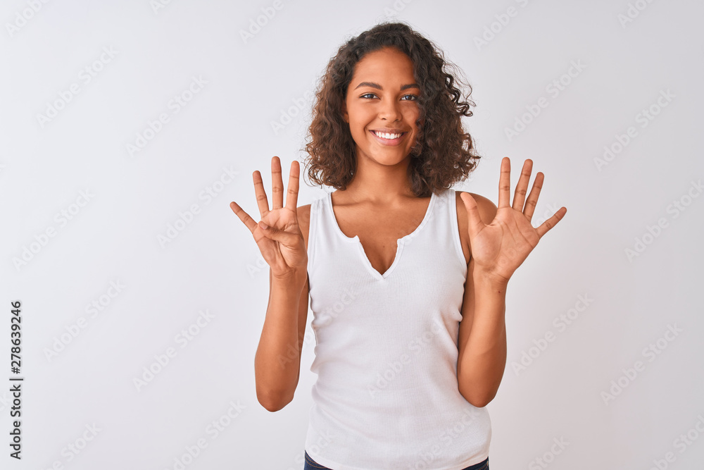 Young brazilian woman wearing casual t-shirt standing over isolated white background showing and pointing up with fingers number nine while smiling confident and happy. Young brazilian woman wearing casual t-shirt standing over isolated white background showing and pointing up with fingers number nine while smiling confident and happy.