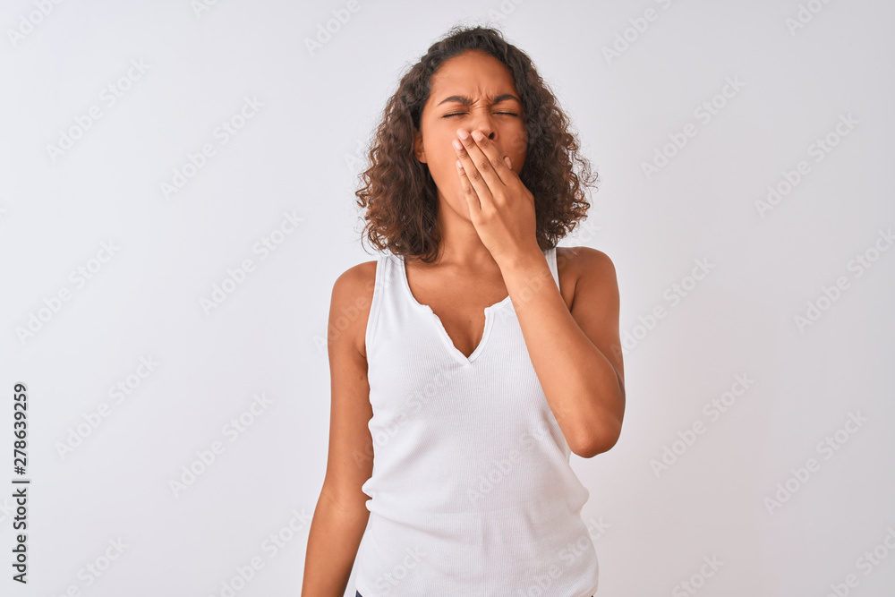 Young brazilian woman wearing casual t-shirt standing over isolated white background bored yawning tired covering mouth with hand. Restless and sleepiness. Young brazilian woman wearing casual t-shirt standing over isolated white background bored yawning tired covering mouth with hand. Restless and sleepiness.